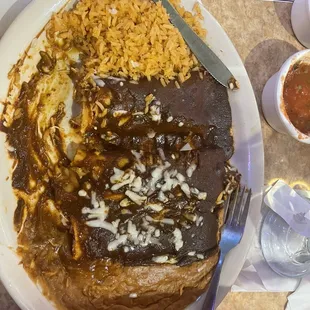 Molé enchiladas side of rice And beans