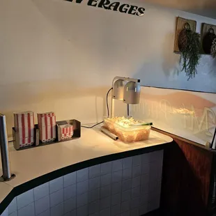 a kitchen with a counter, sink, and beverage dispenser