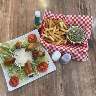 a plate of food and a basket of fries