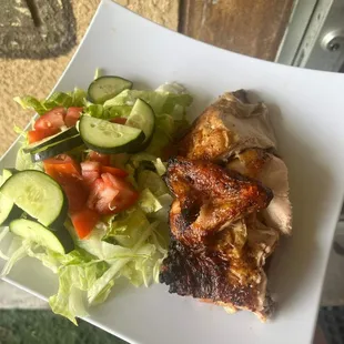 a plate of chicken and a salad