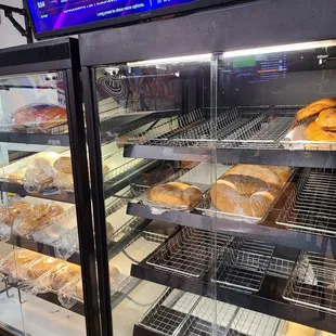 a display case of bread and pastries