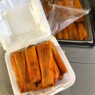 a plastic container filled with tamales
