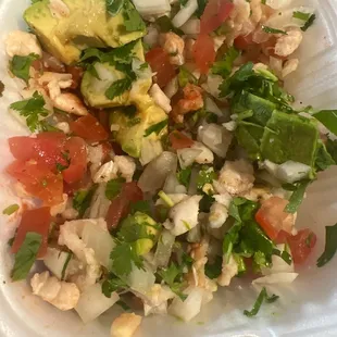 a salad in a styrofoam container