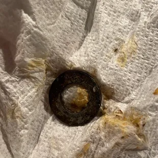 I won't be coming here ever again!  This is a metal washer found in my enchilada.