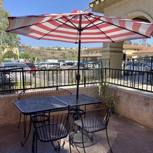 Outside: private patio with properly spaced tables and umbrellas