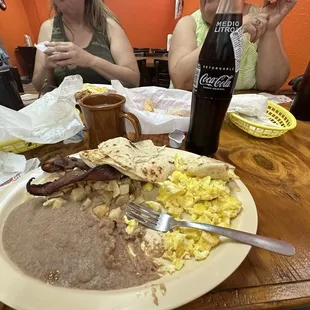 Potatoe and egg breakfast, beans, bacon and a Mexican Coke