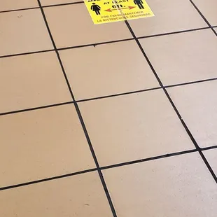 a sign on a tiled floor