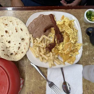 Migas plate, extra side of bacon, and fresh tortillas.