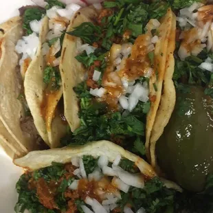 A combo of asada, chorizo, and chorizoqueso tacos