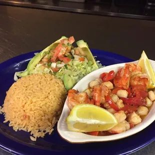 a blue plate with rice and a salad