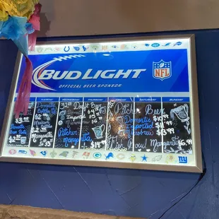 a bud light sign and flowers