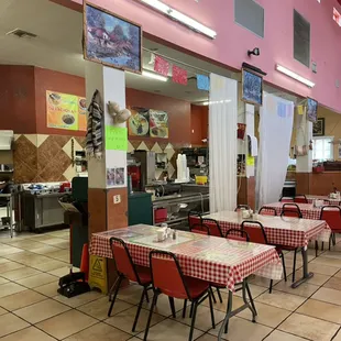 the inside of a restaurant with tables and chairs