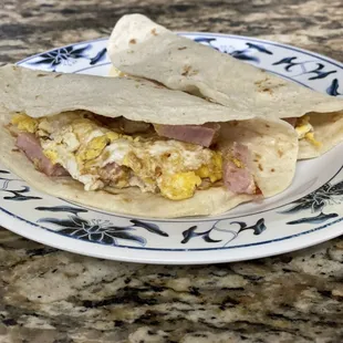 a breakfast burrito on a plate