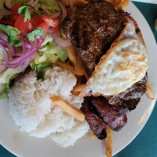 " Mi Rico Peru" Steak Dinner  Flank Steak, an Egg, Fries, Salad, White Rice Platanos and a Cristal Beer.  Excellent Food!