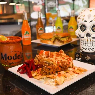 a plate of mexican food and a drink