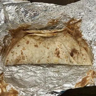 Bean and cheese taco with cheese only on one side and beans all over the crappy tortilla