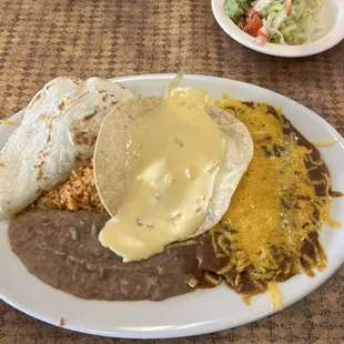 Dinner #1: ground beef taco (sub flour), tostada with queso, (2) enchiladas with rice and refried beans and guacamole salad