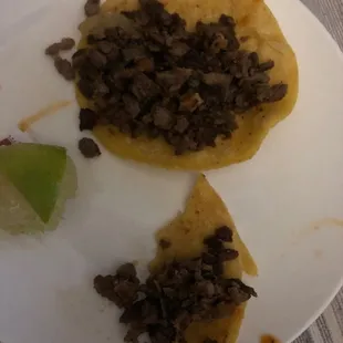 a white plate with two tacos on it
