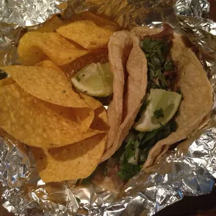 Steak taco with cilantro &amp; a lime for taste.