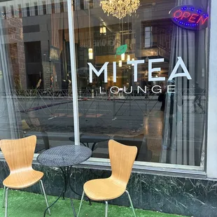 two chairs and a table in front of a window