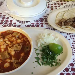 The small menudo bowl, and carnitas taco on the side.