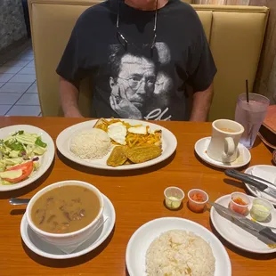a man sitting at a table with food