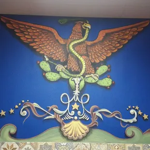 Mural on the wall representing Mexico's coat of arms