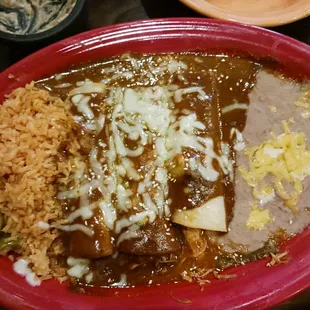 Chicken mole enchiladas with beans and rice