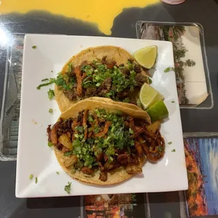 two tacos on a white plate