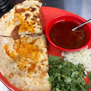 Quesabirria with our signature birria sauce