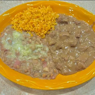 Carne Guisada- Tender beef stewed in savory gravy sauce. Served with rice &amp; beans