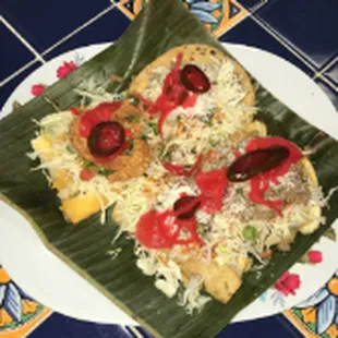 Plato Tipico/Tipico Plate Yucca root with pork cracklins, ground beef with fried Green bananas, 1 enchilada, 2 chicken taquitos