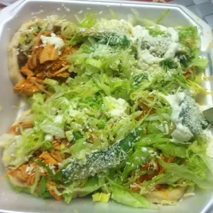 Chicken Sopes (corn tortilla, refried beans, chicken, lettuce, sour cream, and queso fresco)