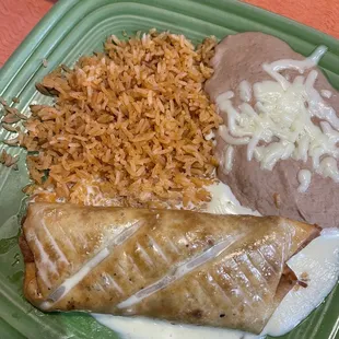 Chimichanga with cheese sauce rice and beans