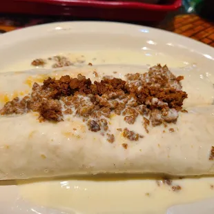 Mi tradicion de queso. Tortillas filled with chicken and the other steak with queso and chorizo on the top