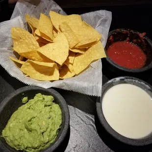 Chips, salsa, guacamole and cheese sauce