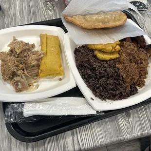 Tamale and pork, black beans and rice with tostones and plantains ropa Vieja Beef empanada