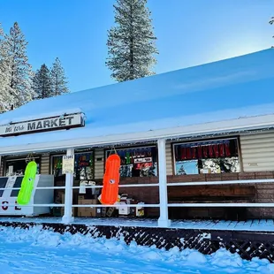 a snow covered building with snowboards