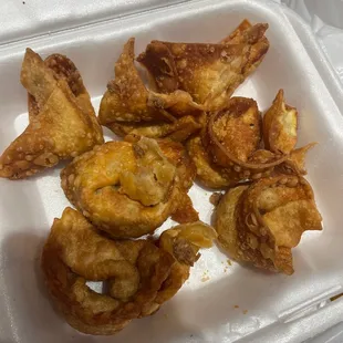 a white takeout container filled with fried food