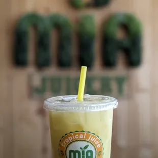 a hand holding a cup with a straw