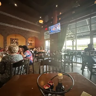 people sitting at tables in a restaurant