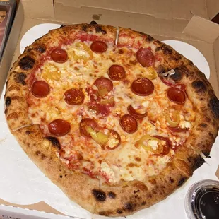 Pepperoni pizza with goat cheese, mozzarella, and pepperoncinis.