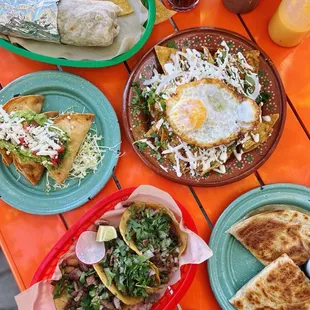 Norteño burrito, crispy shrimp tacos, chilaquiles + egg, tacos de Calle de asada, quesadilla.