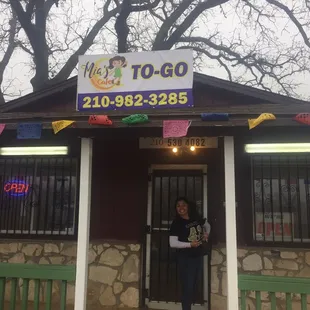 a woman standing in front of a restaurant