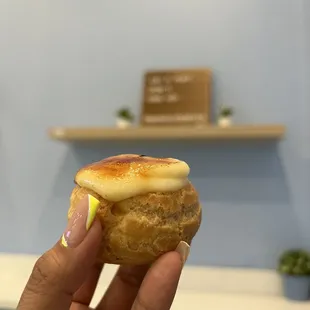 a hand holding a pastry