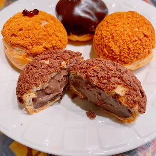 4pcs box cream puffs $8.48. Clockwise: crunchy chocolate  (front halves), boba tea, ganache chocolate, and original.