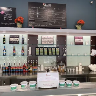 a counter with a variety of gelatos