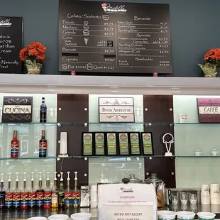 a counter with a variety of gelatos