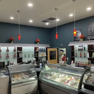 a counter with a variety of gelatos