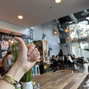a person&apos;s hand pointing at a menu